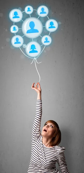 Woman holding social network balloon — Stock Photo, Image