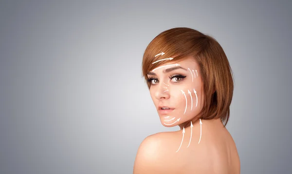 Beautiful girl with facial arrows on her skin — Stock Photo, Image