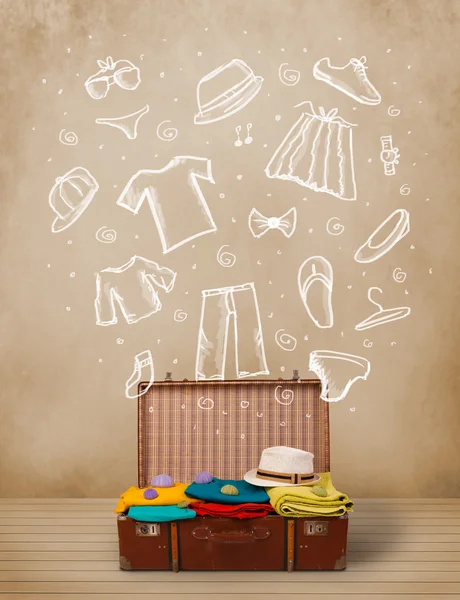Traveler bagage med hand dras kläder och ikoner — Stockfoto