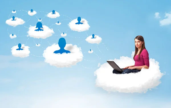 Young woman sitting in cloud with laptop — Stock Photo, Image