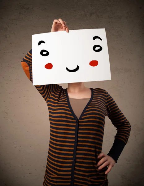 Woman holding a cardboard with a smiley face on it — Stock Photo, Image