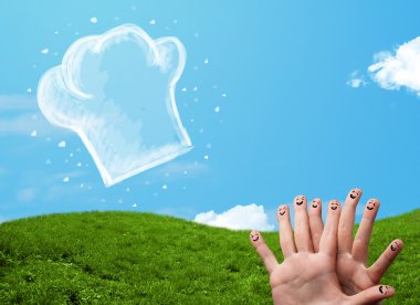 Mutlu gülen yüzlü parmaklar aşçı şapkasının resmine bakıyor.