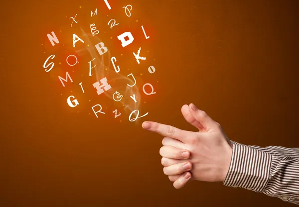 Letters coming out of gun shaped hands — Stock Photo, Image