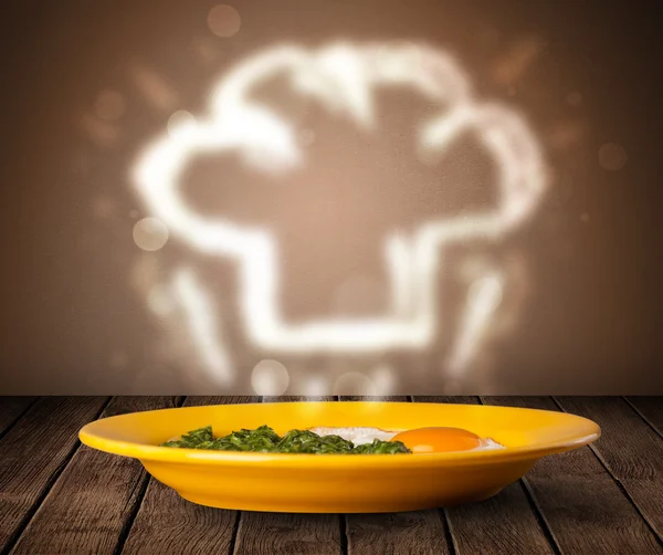 Delicious food plate with chef cook hat — Stock Photo, Image