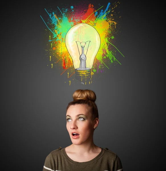 Young woman thinking with lightbulb above her head — Stock Photo, Image