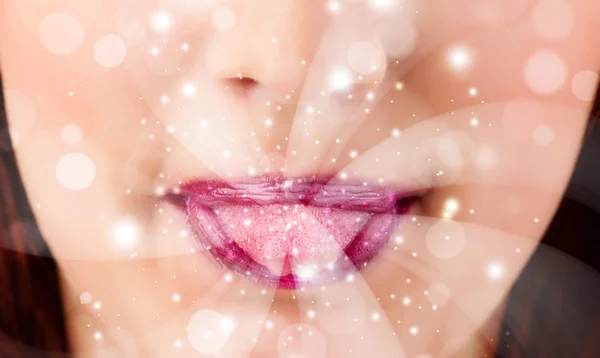 Pretty woman lips blowing abstract white lights — Stock Photo, Image