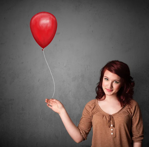 Femme tenant un ballon rouge — Photo