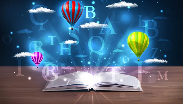 Open book with glowing fantasy abstract clouds and balloons — Stock Photo, Image