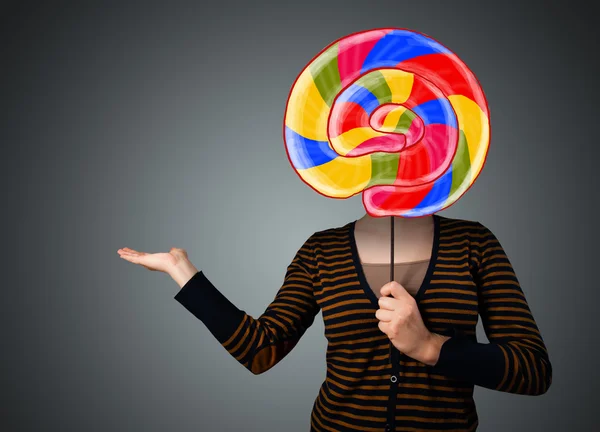 Young woman holding a lollipop — Stock Photo, Image