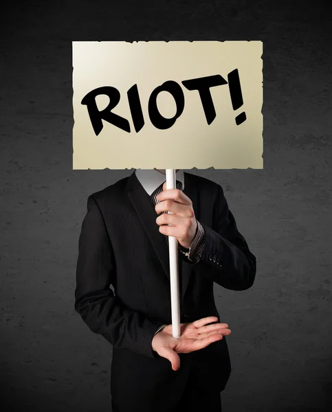 Businessman holding a protest sign — Stock Photo, Image