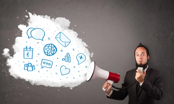 Man shouting into loudspeaker and modern blue icons and symbols — Stock Photo, Image