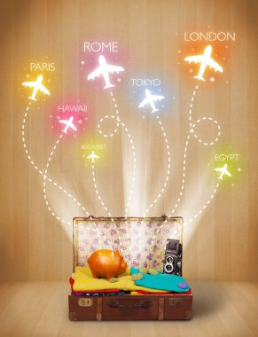 Travel bag with clothes and colorful planes flying out clipart