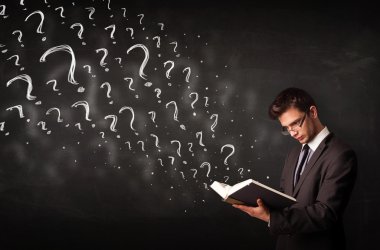 Young man reading a book with question marks coming out from it clipart