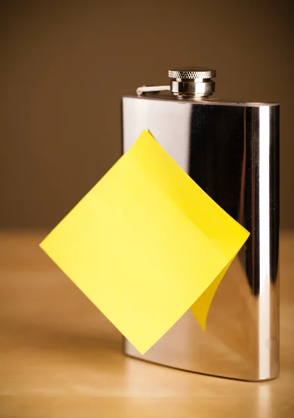 Empty post-it note sticked on hip flask — Stock Photo, Image