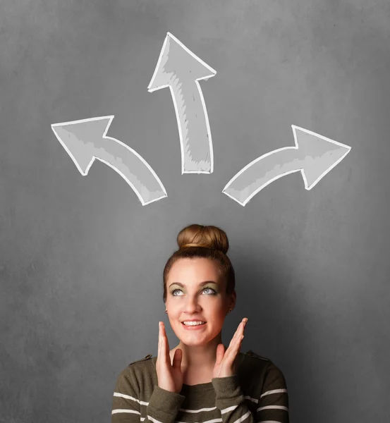 Young woman thinking with arrows above her head — Stock Photo, Image