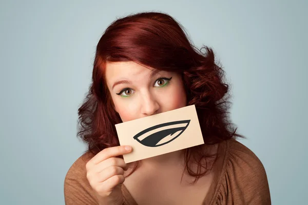 Pretty young girl holding white card with smile drawing — Stock Photo, Image