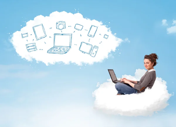 Young woman sitting in cloud with laptop — Stock Photo, Image