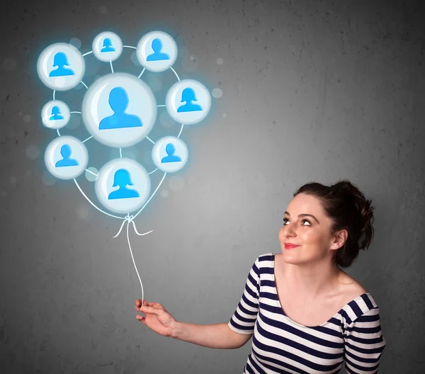 Woman holding social network balloon — Stock Photo, Image