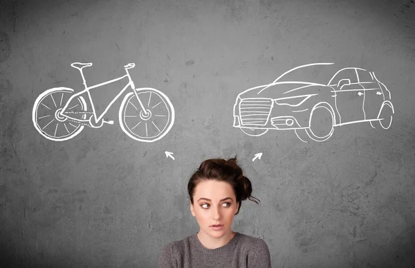 Woman making a choice between bicycle and car — Stock Photo, Image