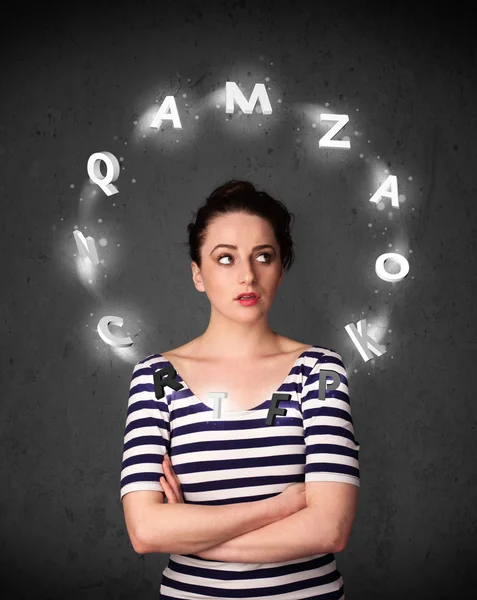 Young woman thinking with letter circulation around her head — Stock Photo, Image