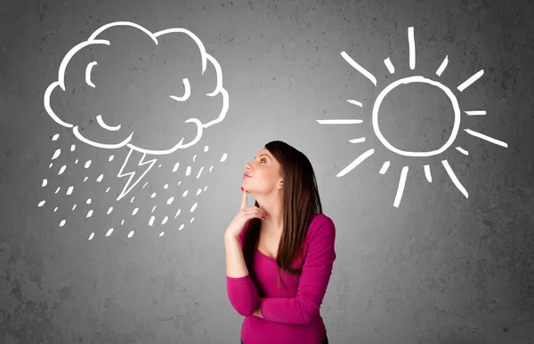 Woman standing between a sun and a rain drawing