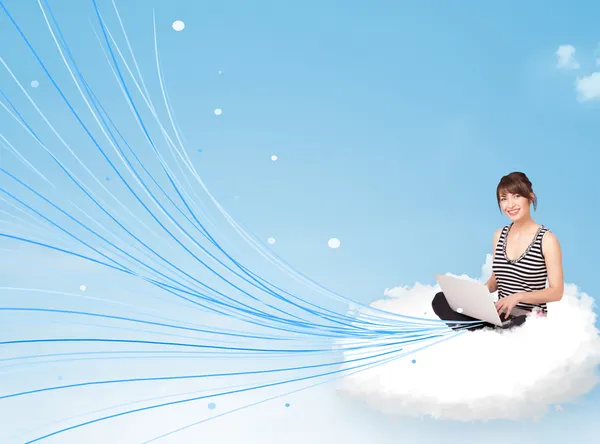 Young woman sitting in cloud with laptop — Stock Photo, Image