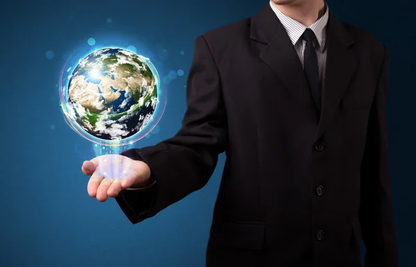 Businessman holding glowing earth globe — Stock Photo, Image