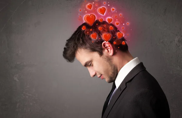 Young person thinking about love with red hearts — Stock Photo, Image