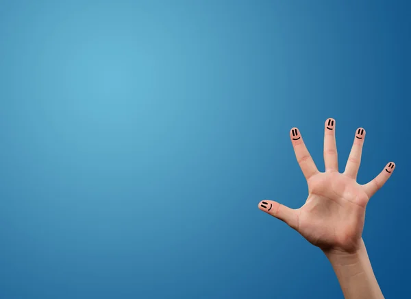 Happy smiley face fingers looking at empty blue background copy — Stock Photo, Image