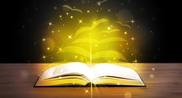 Open book with golden glow flying paper pages — Stock Photo, Image