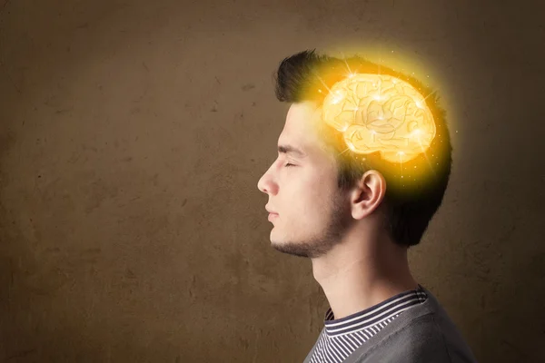 Young man thinking with glowing brain illustration — Stock Photo, Image