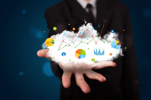 Young businessman presenting cloud with charts and graph icons a — Stock Photo, Image