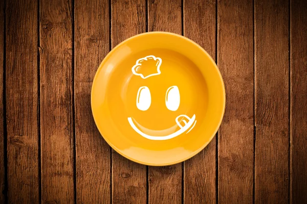 Happy smiley cartoon face on colorful dish plate — Stock Photo, Image