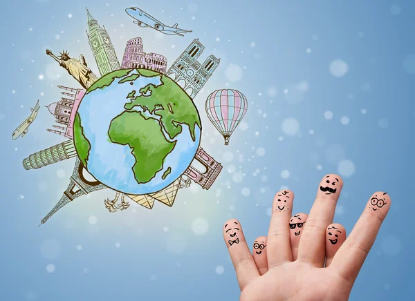 Cheerful finger smileys with famous landmarks of the globe — Stock Photo, Image