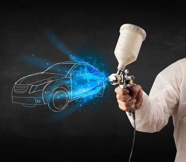 Worker with airbrush gun painting hand drawn car lines — Stock Photo, Image