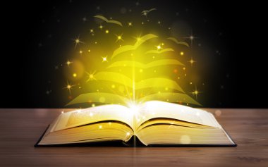 Altından parlak uçan kağıt sayfaları olan açık bir kitap