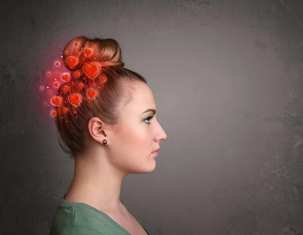 Young person thinking about love with red hearts — Stock Photo, Image