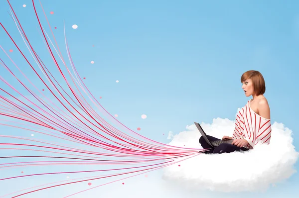 Young woman sitting in cloud with laptop — Stock Photo, Image