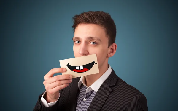 Happy men holding card with funny smiley — Stock Photo, Image