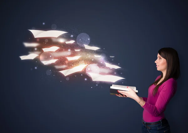 Young lady reading a book with flying sheets coming out of the b — Stockfoto