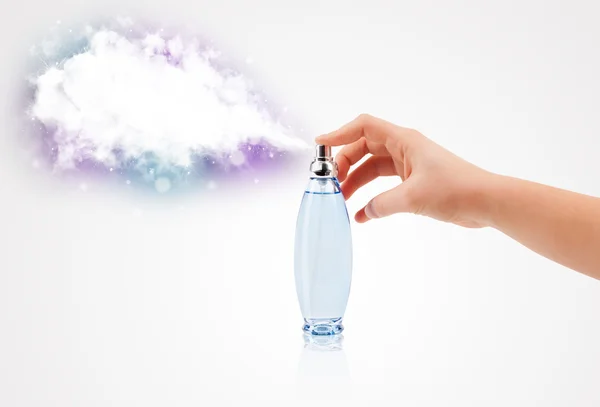 Woman hands spraying colorful cloud — Stock Photo, Image