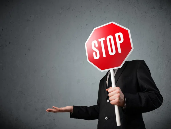 Businessman holding a stop sign — Stock Photo, Image