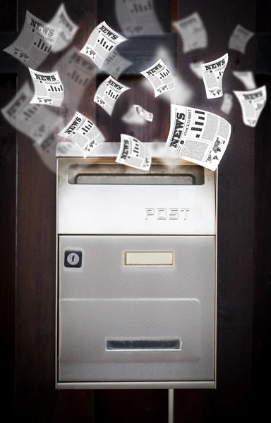 Post box with daily newspapers flying — Stock Photo, Image