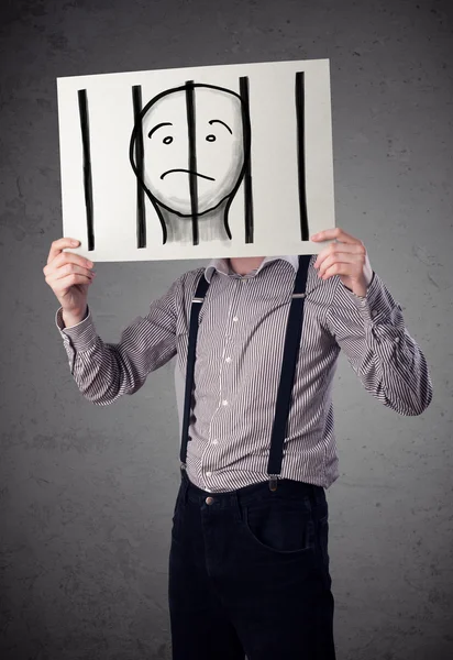 Businessman holding a paper with a prisoner behind the bars on i — Stock Photo, Image