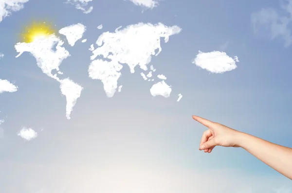 Hand pointing at world clouds and sun on blue sky — Stock Photo, Image