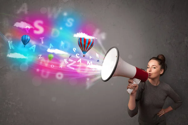 Girl shouting into megaphone and abstract text and balloons come — Stock Photo, Image