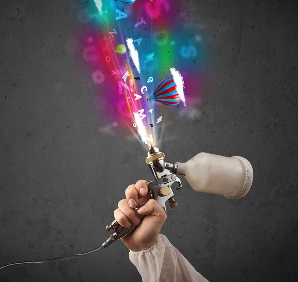 Worker with airbrush and colorful abstract clouds and balloons — Stock Image Worker with airbrush and colorful abstract clouds and balloons Royalty Free Stock Photos