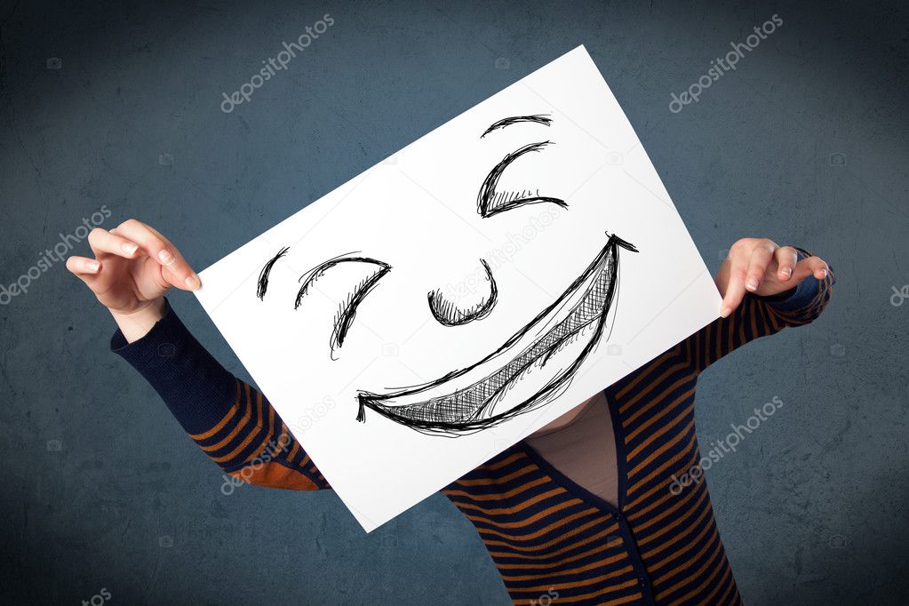 Woman with drawed smiley face on a paper in front of her head