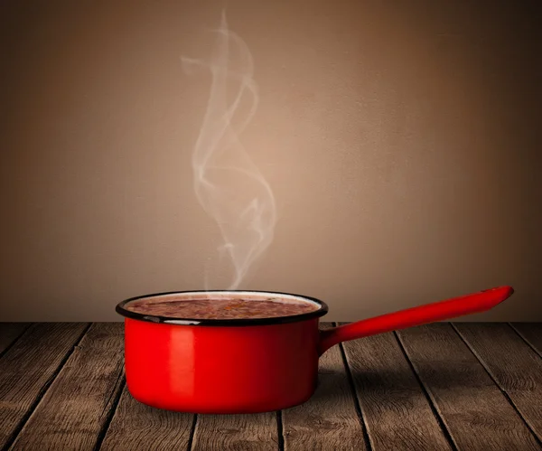 Pot on old wooden table — Stock Photo, Image