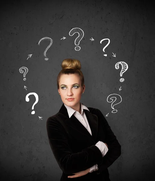 Young woman thinking with question mark circulation around her h — Stock Photo, Image